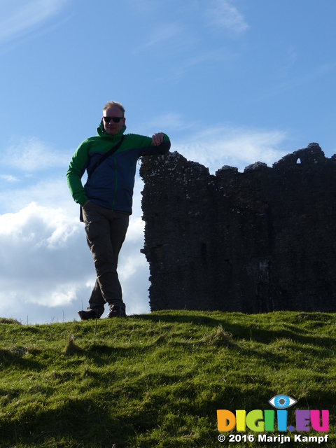 FZ025986 Marijn leaning against Carreg Cennen Castle